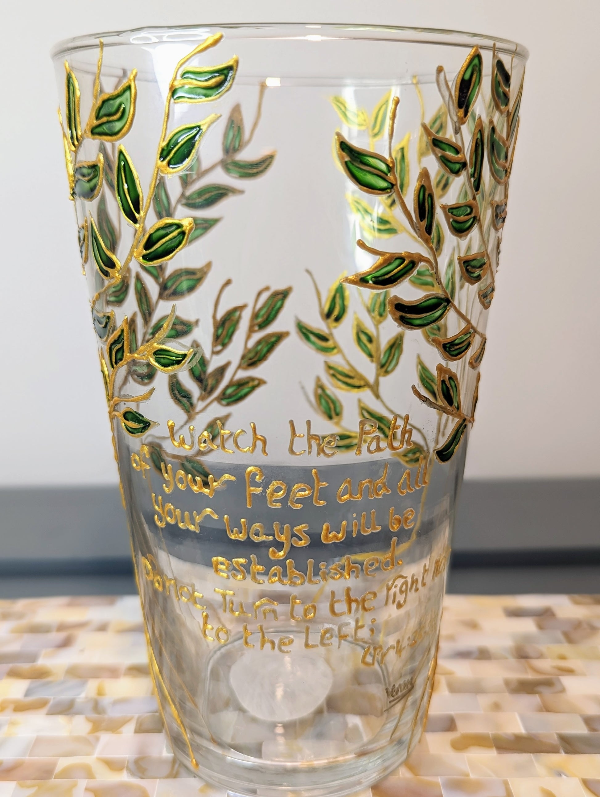 Personalised hand-painted glass vase with green and gold leavesThis hand-painted glass vase features a unique green and gold leaves and tree design, making it a 100% original piece of art. Each vase is hand-painted, ensuring no two are alike. Make it even