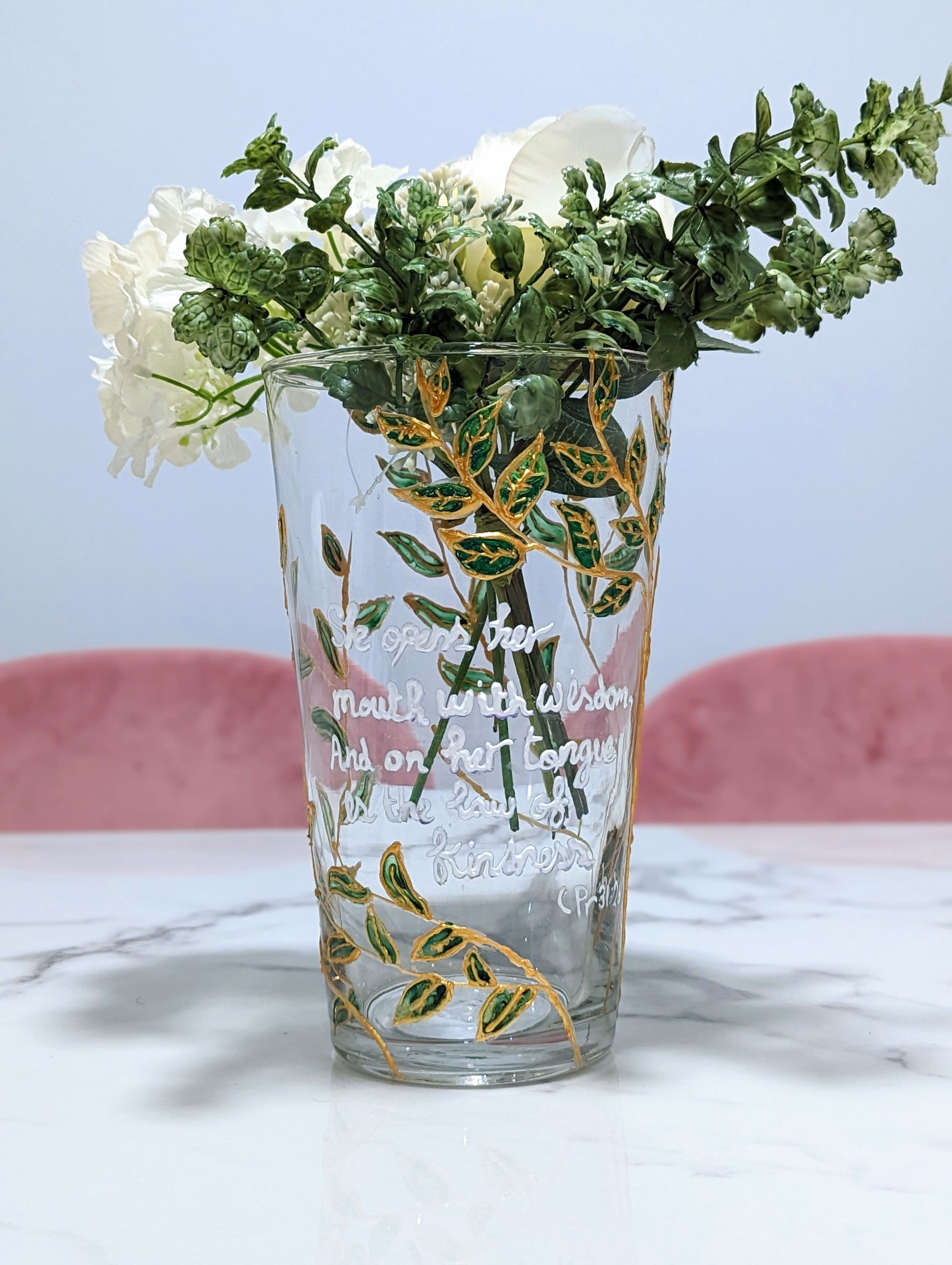 Personalised hand-painted glass vase with green and gold leavesThis hand-painted glass vase features a unique green and gold leaves and tree design, making it a 100% original piece of art. Each vase is hand-painted, ensuring no two are alike. Make it even