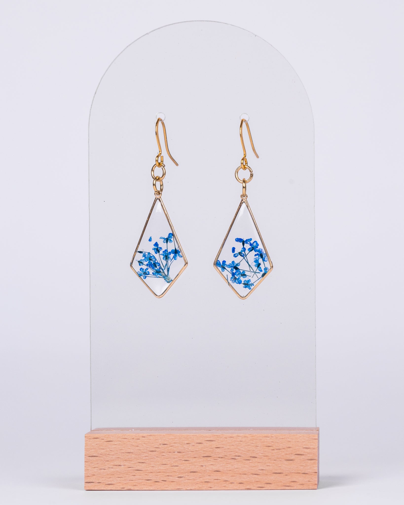 Handmade gold-plated diamond earrings with real blue and white flowers in clear resin – elegant floral jewellery from Australia.