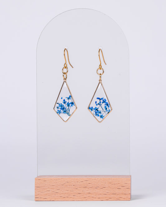 Handmade gold-plated diamond earrings with real blue and white flowers in clear resin – elegant floral jewellery from Australia.