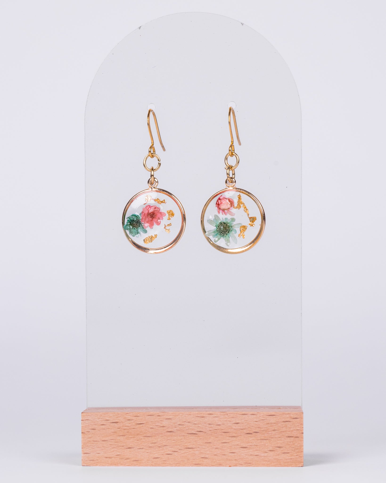 Handmade gold-plated stud earrings with real pink and white flowers in clear resin and gold flakes – elegant floral jewellery from Australia.