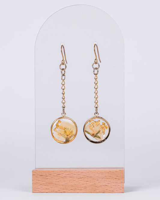 Gold-plated long dangling earrings with real yellow flowers preserved in resin – handmade floral jewellery crafted in Australia.

