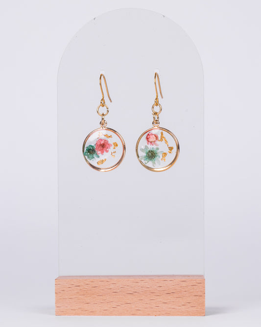 Handmade gold-plated stud earrings with real pink and white flowers in clear resin and gold flakes – elegant floral jewellery from Australia.

