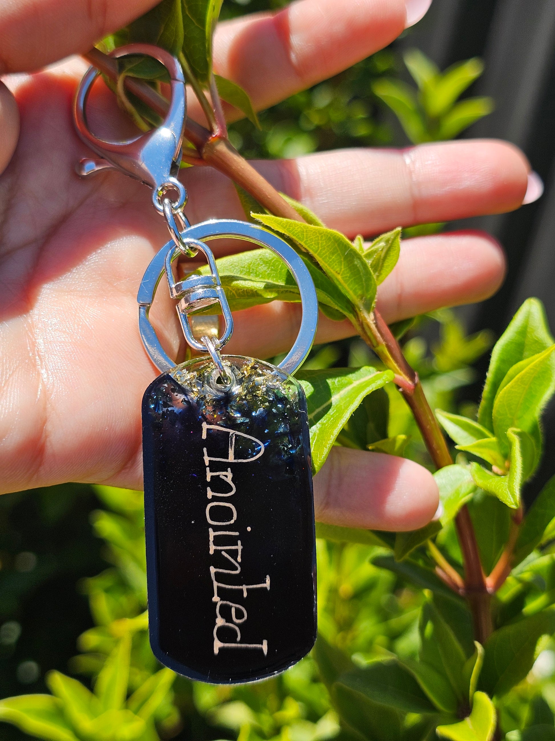 Personalised hand-made keychains for MenTransform your keychain with a custom-made, premium-quality keychain crafted from top-grade epoxy resin and a silver-plated chain. This combination ensures superior durability and scratch-resistance. Make a statemen